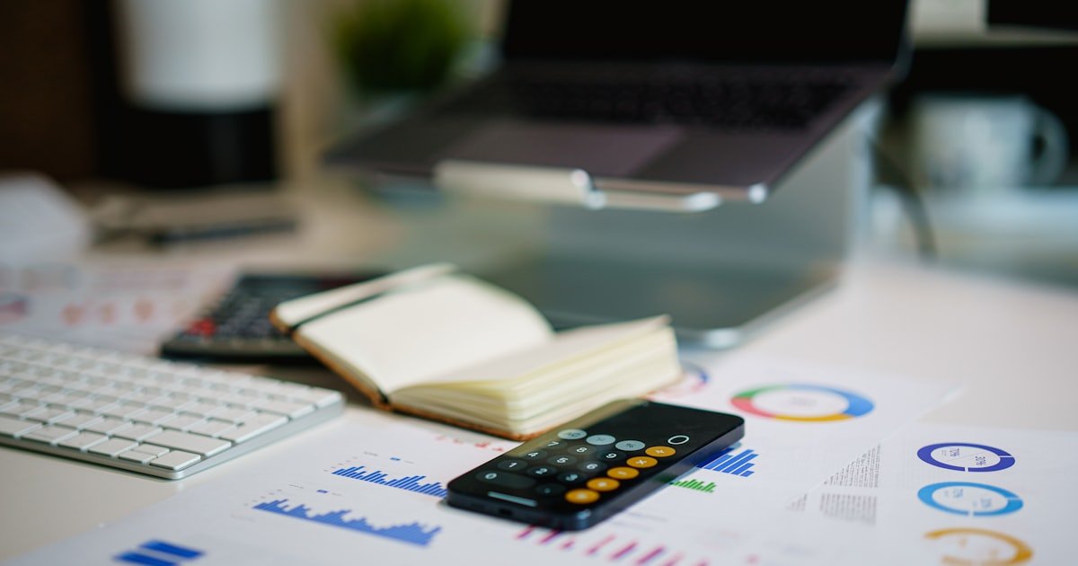 office desk with financial charts showing how to save money fast