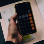Budget breakdown showing the 50 30 20 rule with three categories — needs wants and savings on a clean desk