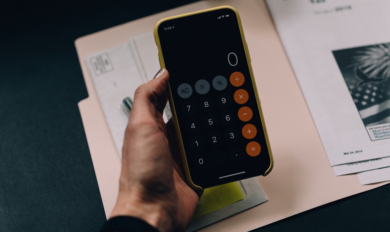 Budget breakdown showing the 50 30 20 rule with three categories — needs wants and savings on a clean desk