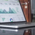 person using laptop financial budgeting app tools 2026